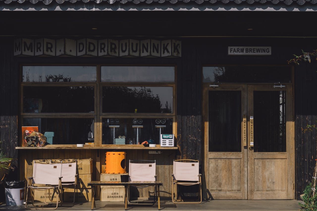 Charming farm brewing entrance with rustic decor and outdoor seating area.